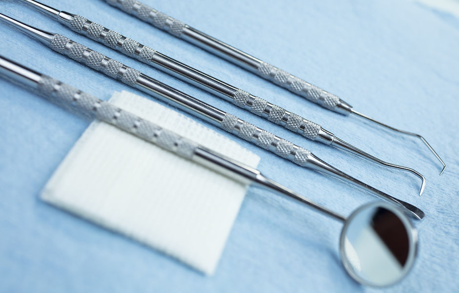 Dental Picks, Mirror and Gauze on a Pape